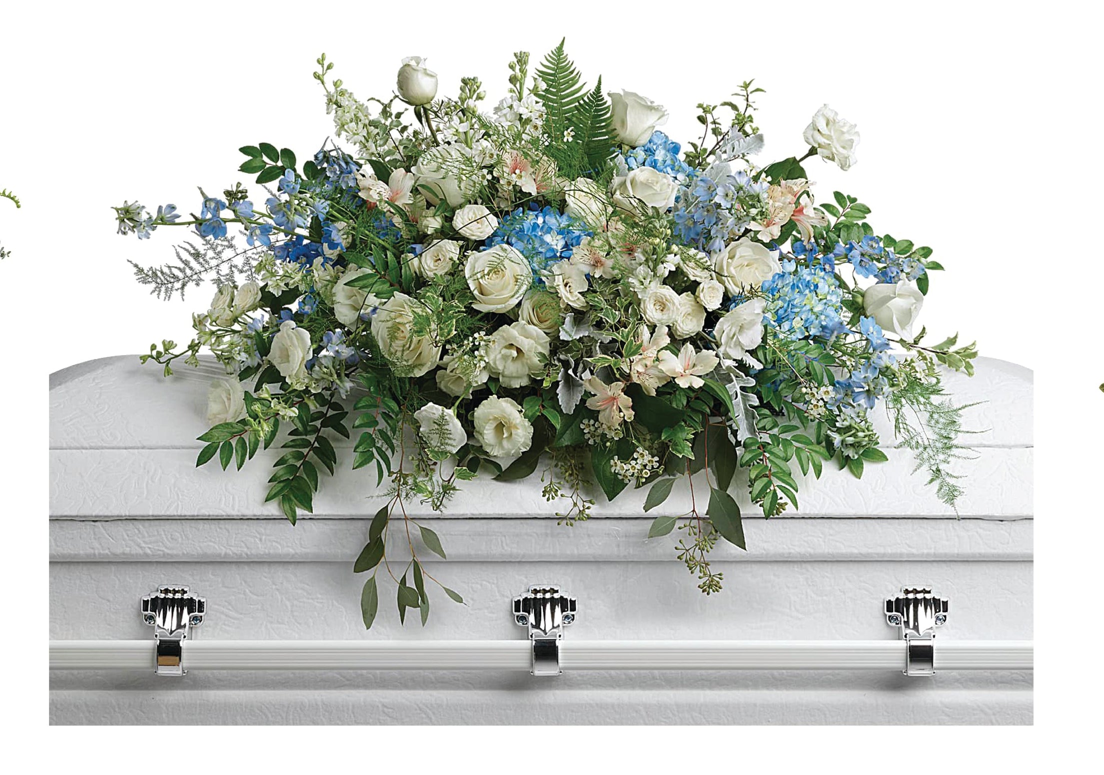 White casket with a large floral casket spray of white and blue flowers.