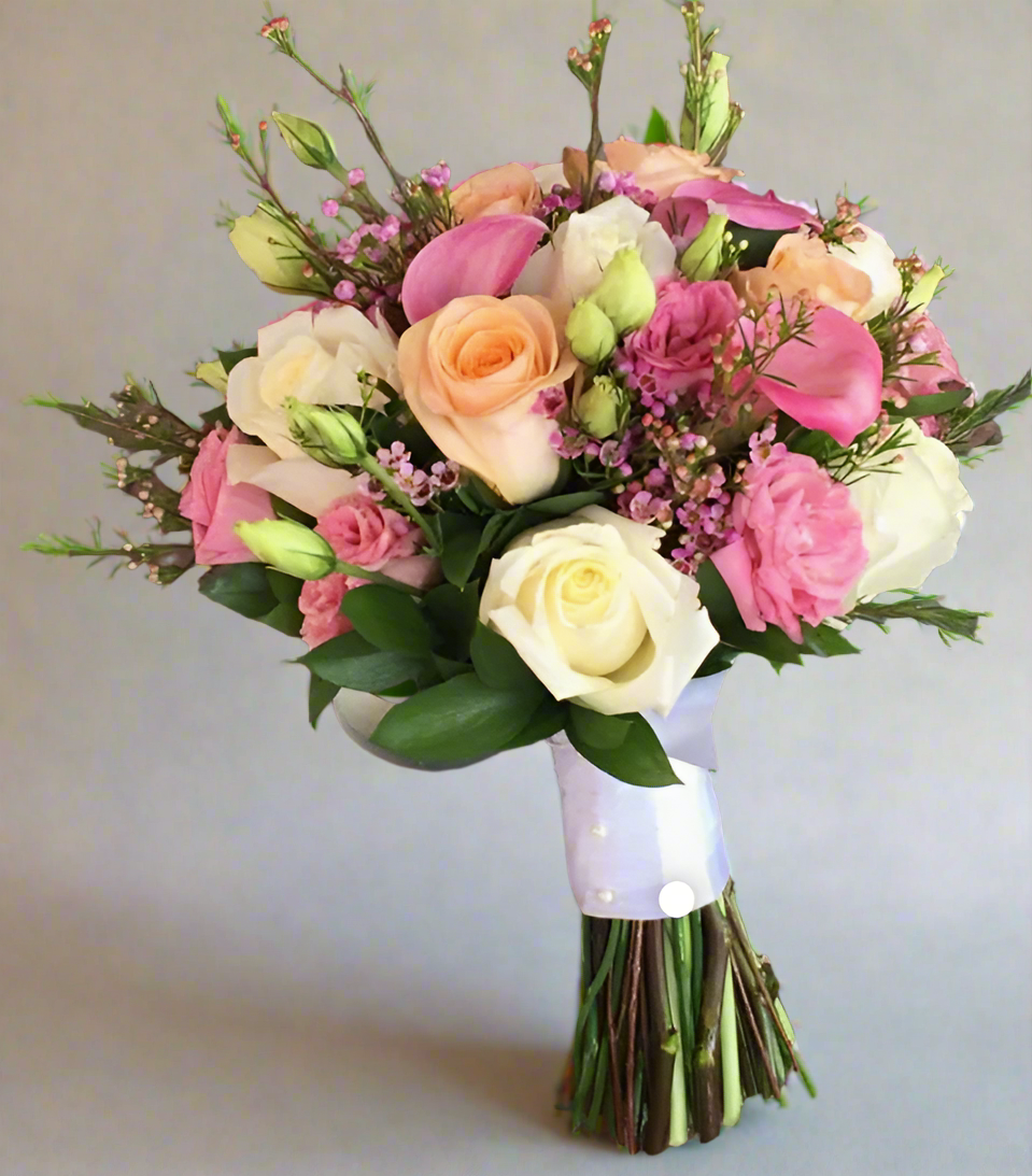 A prom posy bouquet with a variety of flowers including gerberas and roses, predominantly in pink, peach, and white colors.
