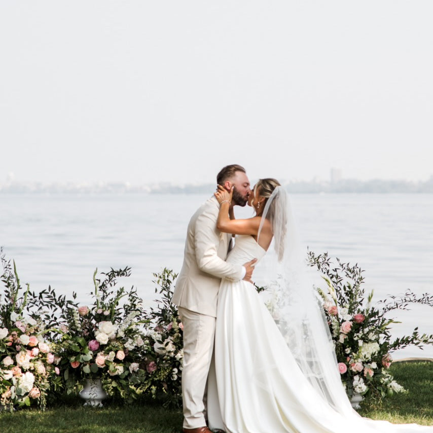 Wedding couple embracing with florals by Olson's Flowers, Mount Horeb WI