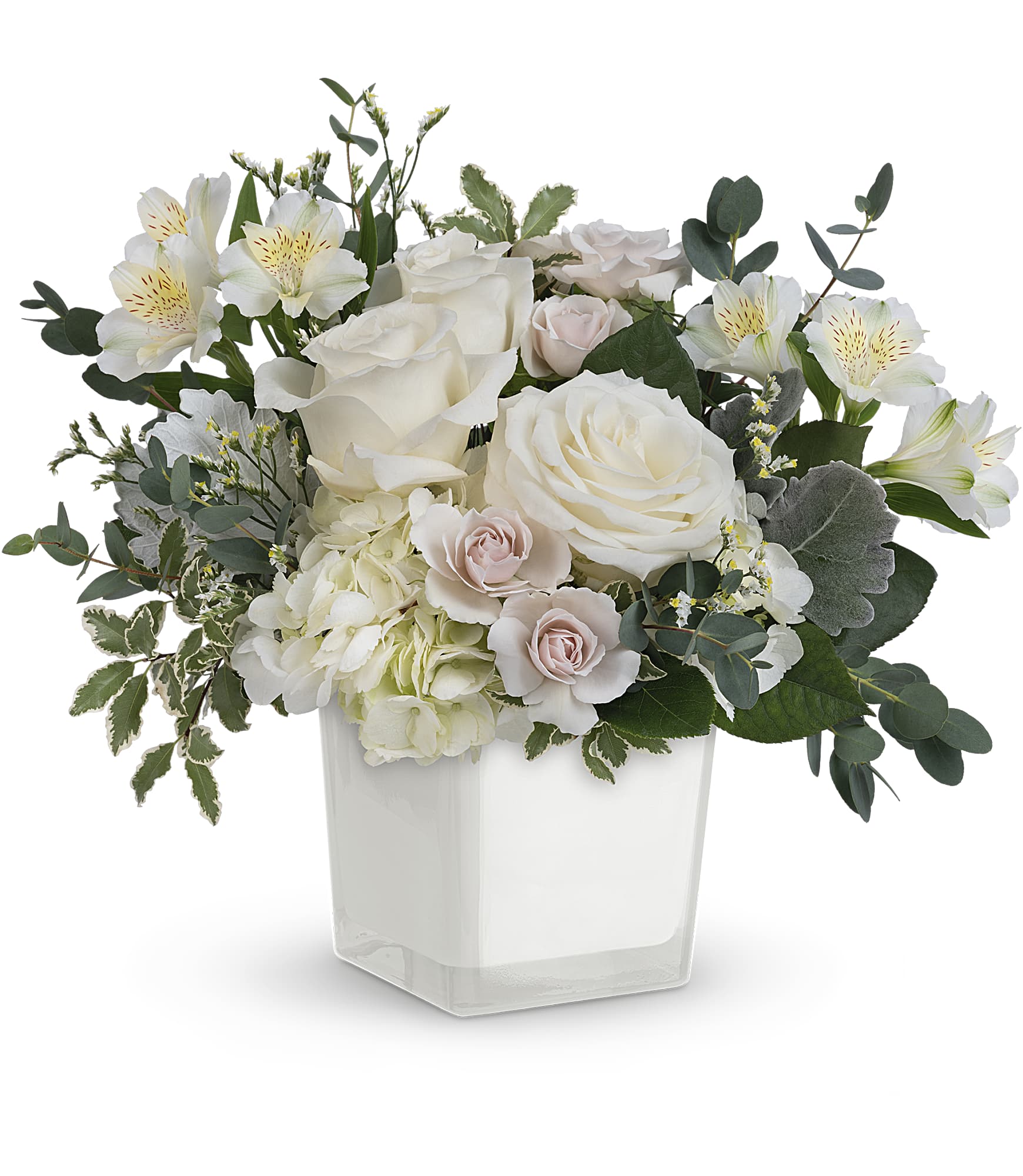 Floral arrangement with white and pink flowers in a clear vase on a white background