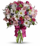 Bouquet of flowers with a pink ribbon in a clear vase on a white background