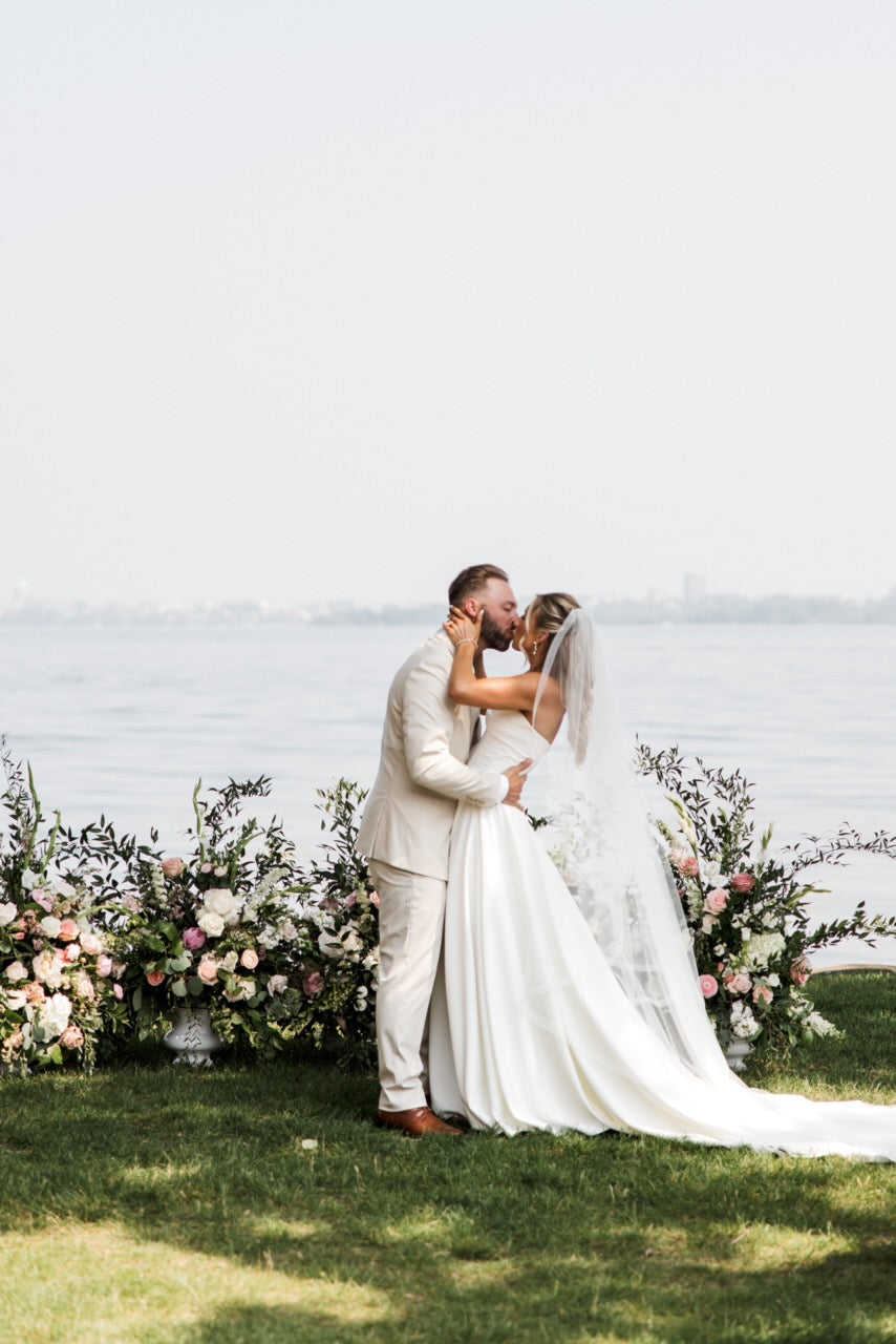 Wedding couple embracing with florals by Olson's Flowers, Mount Horeb WI