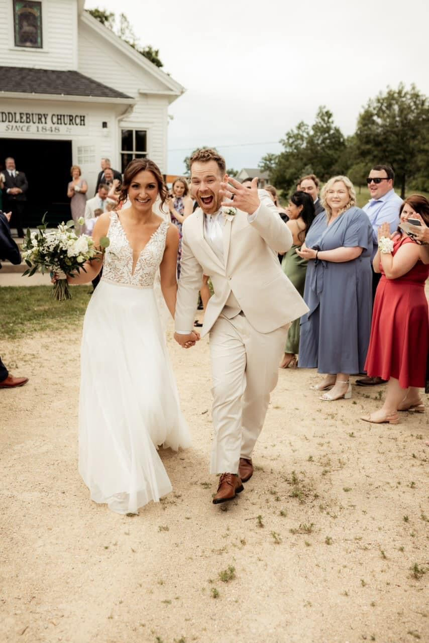 Wedding couple with floral arrangements by Olson's Flowers, Mount Horeb florist