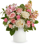 Bouquet of pink, white, and green flowers in a white vase on a white background