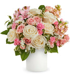 Bouquet of pink and white flowers in a white vase on a white background
